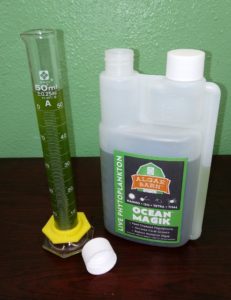 ocean-magik-live-phyoplankton-test-tube-vial-algaebarn OceanMagik Live Phytoplankton next to a test tube measuring 50ml can be used to help with mandarin goby fish care